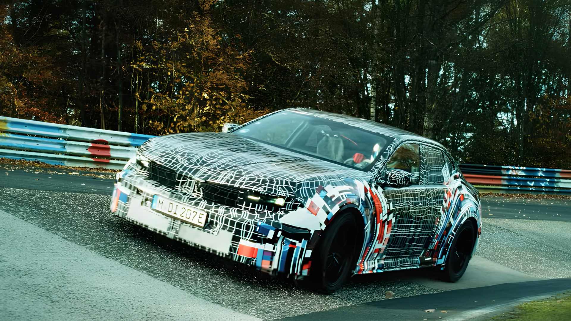 Protótipo camuflado do BMW iM3 elétrico durante testes em pista molhada no circuito de Nürburgring, na Alemanha