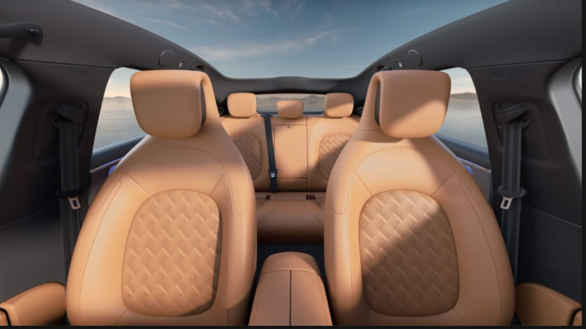 Interior do Smart #6 visto de frente para trás para frente, mostrando os dois bancos dianteiros e o banco traseiro em couro caramelo. O teto panorâmico de vidro revela um céu azul com nuvens, ampliando a sensação de espaço.