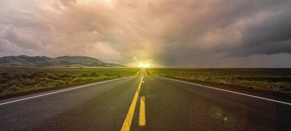 Foto de uma longa estrada sumindo no horizonte